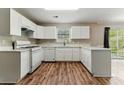 Bright kitchen with white cabinets, countertops, and stainless steel appliances at 3267 Forrest Bluff Way, Lithonia, GA 30038