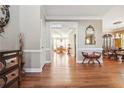Elegant foyer featuring hardwood floors, decorative mirror, and seamless transition into the dining area at 405 N Pine Dr, Alpharetta, GA 30022