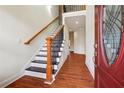 Inviting foyer with hardwood floors, staircase, and front door with decorative glass at 7902 West Shore Cir, Riverdale, GA 30296