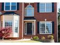 Close-up of the front door and portico, highlighting brick facade and neat landscaping at 2875 Factor Walk Blvd, Suwanee, GA 30024