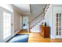 Inviting foyer with hardwood floors, staircase, and stylish console table at 1864 Crestridge Ne Pl, Atlanta, GA 30345