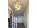 Grand entryway with an ornate chandelier, dark hardwood floors, and high ceilings at 2152 Castlewood St, East Point, GA 30344