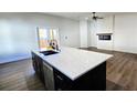 Modern kitchen with stainless appliances, an island with a sink, and white quartz countertops at 2152 Castlewood St, East Point, GA 30344