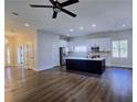 Open concept living room, dining room, and kitchen with an island and white cabinets at 2152 Castlewood St, East Point, GA 30344