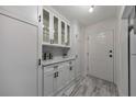 Bright entryway with white cabinets, black hardware, gray flooring and a white door at 300 Johnson Ferry Ne Rd # A1008, Atlanta, GA 30328