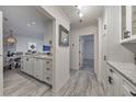 Hallway view with marble counters, white cabinets, gray flooring and an open doorway at 300 Johnson Ferry Ne Rd # A1008, Atlanta, GA 30328