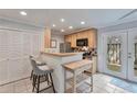 Bright kitchen boasts modern appliances, breakfast bar, and access to outdoor patio at 8 Arpege Nw Way, Atlanta, GA 30327