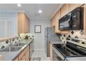 Stylish kitchen features stainless steel appliances and elegant backsplash design at 8 Arpege Nw Way, Atlanta, GA 30327