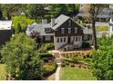 Beautiful two-story home with manicured lawn, stone steps, and mature trees offering a charming curb appeal at 219 Little John Ne Trl, Atlanta, GA 30309