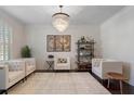 Bright living room featuring stylish furniture, modern shelving, and a large area rug at 240 Brookwood Estates Dr, Alpharetta, GA 30005
