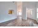 Spacious living area with light wood floors, a peek-through to the kitchen, and a bright entryway at 6502 Wellington Chase Ct, Lithonia, GA 30058
