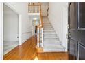 Bright foyer with hardwood floors and staircase leading to the second level at 3395 Hunters Place, Stonecrest, GA 30038