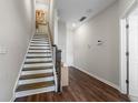 Inviting foyer with hardwood floors, a staircase, and neutral wall paint creates a welcoming atmosphere at 6023 Skellig St, Norcross, GA 30071