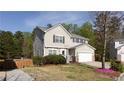 Inviting two-story home featuring a manicured lawn, two-car garage, and welcoming entrance at 1924 Sweet Flag Rd, Lawrenceville, GA 30045