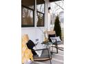 Close up on the covered porch with rocking chairs and stylish decor for a cozy feel at 3128 Cedar St, Scottdale, GA 30079