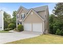 Lovely home featuring a two-car garage, long driveway, and beautifully landscaped yard at 7040 Magnolia Park Ln, Norcross, GA 30093