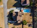 Aerial view of the property showcasing a private backyard with a sparkling blue pool, lush greenery, and ample space at 2006 Hubbard Ct, Villa Rica, GA 30180