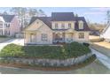 Inviting two-story home featuring a brick and siding facade, complemented by a meticulously landscaped front yard at 2006 Hubbard Ct, Villa Rica, GA 30180