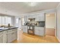 Kitchen showcases updated cabinets, stainless steel appliances, and natural light at 3075 Superior Dr, Dacula, GA 30019
