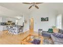 Open concept living room with vaulted ceilings adjacent to kitchen, hardwood floors, and neutral tones at 3075 Superior Dr, Dacula, GA 30019