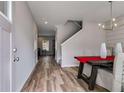 Entryway with wood floors, a dining table, and an adjacent staircase at 804 Trestle Creek Ct, Temple, GA 30179