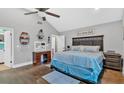 Spacious main bedroom with a vaulted ceiling, ceiling fan and dark wood furniture at 1965 Midway Rd, Douglasville, GA 30135