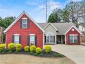 Charming single Gathering home with red brick and manicured landscaping in a well-maintained front yard at 2112 Little River Dr, Suwanee, GA 30024