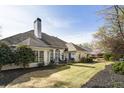 Expansive backyard with a well-maintained lawn, patio area, mature trees and exterior fireplace at 3290 Winthrop Ne Cir, Marietta, GA 30067