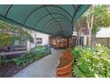 Apartment building entrance with benches, landscaping, and a covered walkway leading to the doorway at 1800 Clairmont Lk # A427, Decatur, GA 30033