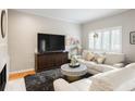 Cozy living room featuring a plush sofa, stylish decor, and a bright window at 67 25Th Nw St # 5, Atlanta, GA 30309