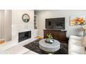 Bright living room with a fireplace, modern furnishings, and hardwood floors at 67 25Th Nw St # 5, Atlanta, GA 30309