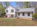Charming split level home featuring stone accents, covered entry porch, and well-maintained front yard at 1143 Cedar Log, Austell, GA 30168
