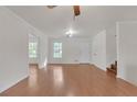 Bright living room featuring hardwood floors, neutral walls, modern lighting, and easy access to other rooms at 1143 Cedar Log, Austell, GA 30168