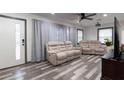 Bright living room features wood-look flooring and plush reclining sofas at 1486 Akridge Nw St, Atlanta, GA 30314