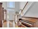 Bright foyer featuring hardwood floors, piano, staircase, and an abundance of natural light at 226 Double Gate Ct, Sugar Hill, GA 30518