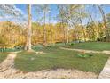 Spacious backyard with lush green grass leading to the lake at 1840 Brandon Hall Dr, Atlanta, GA 30350