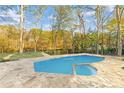 Inviting in-ground pool with spa and stone surround overlooking backyard at 1840 Brandon Hall Dr, Atlanta, GA 30350