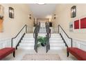 Grand entryway with tiled floors, staircase, decorative lighting, and stylish black railings at 225 E Ponce De Leon Ave # 317, Decatur, GA 30030