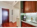 Hallway features hardwood floors, a bar area with wood cabinets, and marble countertop, near the entry door at 3300 Windy Ridge Se Pkwy # 612, Atlanta, GA 30339