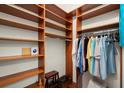 Spacious walk-in closet with custom wood shelving and rods for ample storage space at 3300 Windy Ridge Se Pkwy # 612, Atlanta, GA 30339