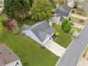Aerial view of a well-maintained home with a spacious yard, long driveway, and established landscaping at 3227 Grove Trl, Acworth, GA 30101