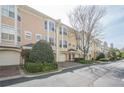 Street view of attractive townhomes with brick driveways and attached garages at 375 Highland Ne Ave # 903, Atlanta, GA 30312