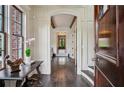 Inviting foyer with dark wood floors, white wainscoting, and views into other rooms of the home at 603 E Paces Ferry Ne Rd, Atlanta, GA 30305
