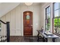 Bright foyer with dark wood floors, decorative front door, wainscoting, and a large window at 603 E Paces Ferry Ne Rd, Atlanta, GA 30305