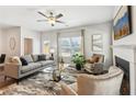 Inviting living room features a fireplace, ceiling fan, neutral decor, and an outside view at 6351 Towhee Way, Morrow, GA 30260