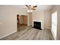 Bright living room with fireplace, ceiling fan, and wood flooring at 5364 Hickory Knl, Norcross, GA 30071