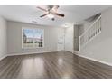 Spacious living room featuring wood floors, a ceiling fan, and natural light at 1730 Stanwood Nw Dr, Kennesaw, GA 30152