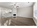 Open-concept living room with a fireplace and wood flooring at 1730 Stanwood Nw Dr, Kennesaw, GA 30152
