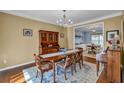 Elegant dining room with hardwood floors, stylish chandelier, and ample seating for entertaining at 735 Ambur Cove Way Nw, Lawrenceville, GA 30043