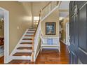 Inviting foyer boasts gleaming hardwood floors, elegant staircase, and stylish decor at 735 Ambur Cove Way Nw, Lawrenceville, GA 30043